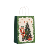 Christmas-themed gift bag with a nutcracker and tree design on a white background