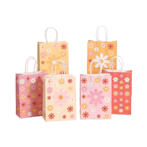 Set of colorful floral paper gift bags on a white background