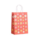 Small paper gift bag with floral pattern on a white background