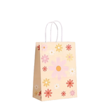 Paper gift bag with floral pattern on a white background