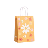 Yellow paper bag with floral patterns on a white background