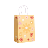 Yellow paper gift bag with floral patterns on a white background