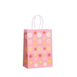 Pink paper gift bag with floral pattern on a white background