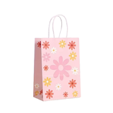 Pink paper gift bag with floral pattern on a white background
